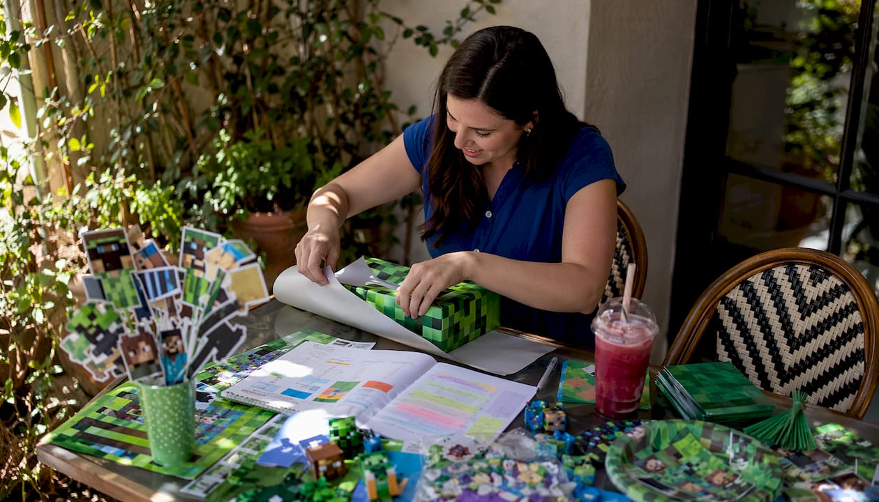 Woman organizing Minecraft birthday party supplies at home