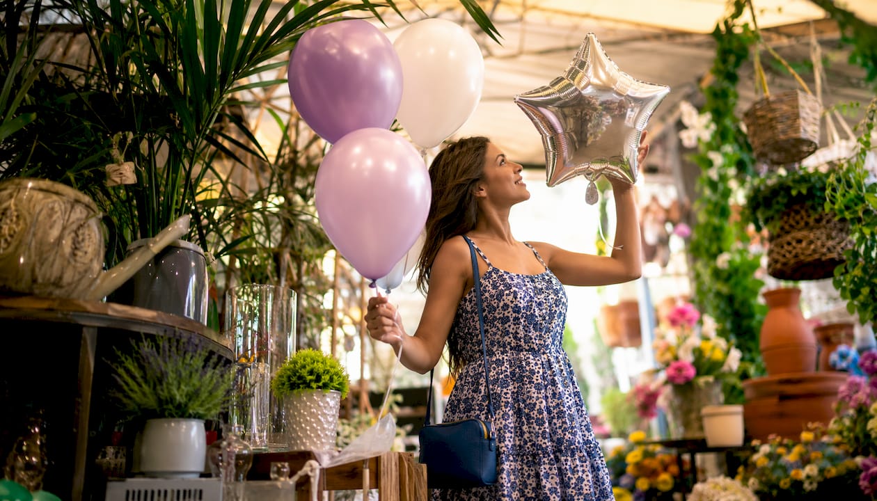 Woman shopping for wedding balloons in store