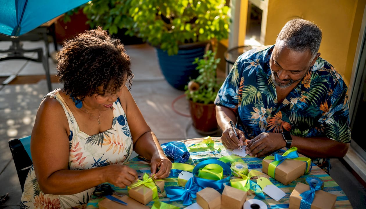 Couple preparing anniversary party favors at table