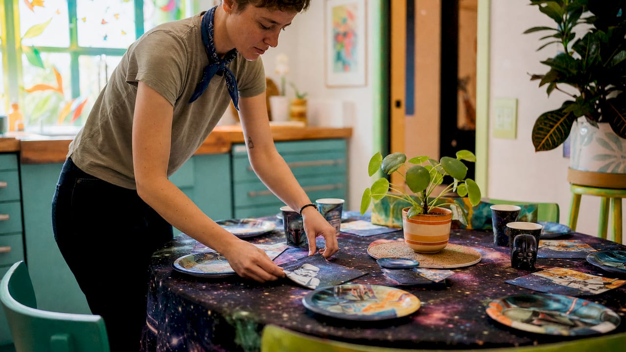 Parent setting Star Wars party supplies on table