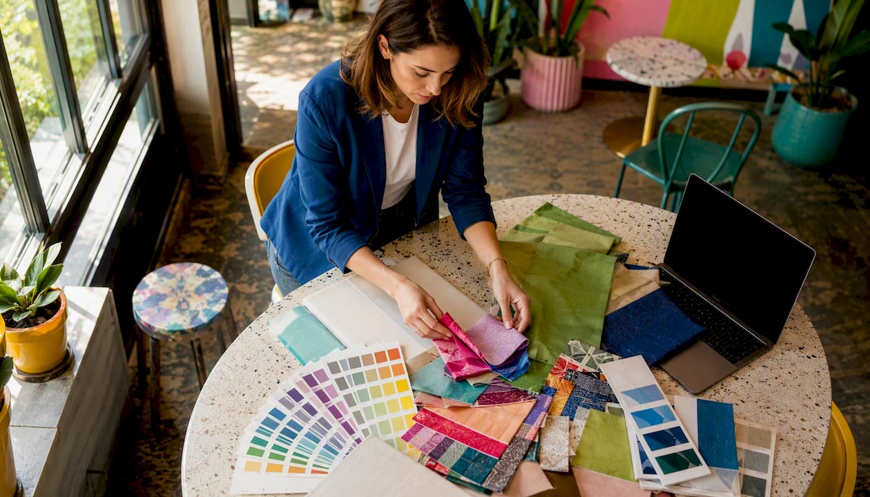 Woman planning party color scheme at home table