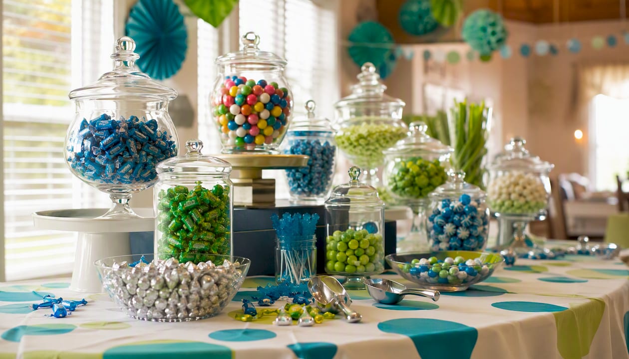 Colorful candy buffet table with jars and scoops