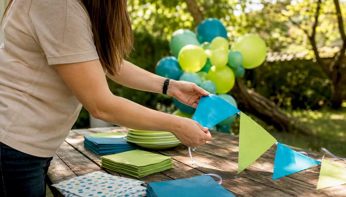 Hands arranging party decoration set on table