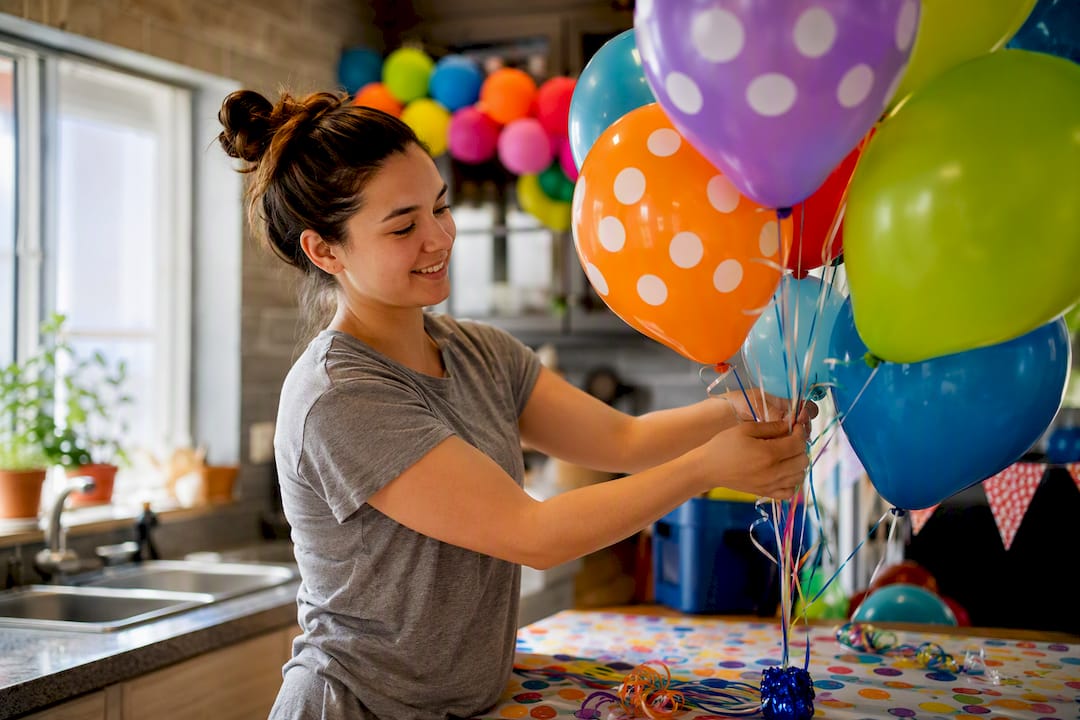 Air-filled foil balloons on sticks in box