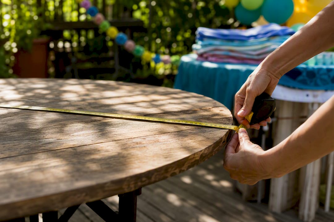 Hands measuring diameter of round table