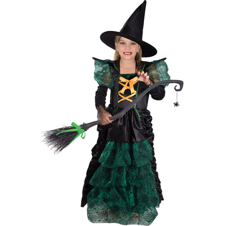 Model wearing Lola Stars girls' witch costume: black and green spiderweb gown with orange lacing and pointed black hat